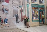 Judy attentively listens to the guitar player in the Fresque des Québecois mural on the side of a building in the Lower Town.