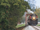 A deep steamboat whistle echos off the mill as 630 passes through the small town of  Trion Ga 