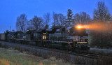 The rain is coming down hard as NYC 1066 leads an empty coal train through the siding at Waddy 