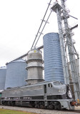 The Melvin grain elevator towers over the IC 101, both symbols of the Heartland 