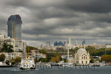 Dolmabahce Mosque with boats at Kabatas terminal and modern buildings on the Bosphorus Strait Istanbul