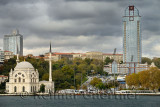 Dolmabahce Mosque surrounded by modern buildings on the Bosphorus Strait Istanbul