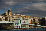 Galata Tower and Bridge in sun with clouds from Eminonu terminal Istanbul on the Goden Horn