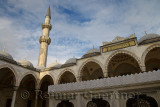 Minaret in sun from inner courtyard with ablution fountain at Suleymaniye Mosque Istanbul