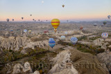 Hot air balloons over the Red Valley and Goreme Nation Park in Cappadocia Turkey at dawn with moon
