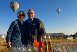 Hot air balloon pilot celebrating with female tourist a successful flight in Cappadocia Turkey