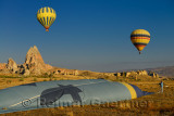 Operator folding a deflating hot air balloon on the ground in Cappadocia Turkey