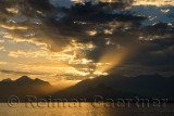 Mediterranean Sea at Antalya harbour Turkey with sunset sunbeams over mountains