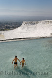 Two boys playing in mineral waters of travertine pools at Pamukkale Turkey