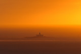 Lighthouse in the Sunset Mist