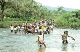 Crossing the Bagumbayang River on way to a funeral