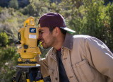 Angel Pena using a total station