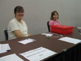 Dan's wife Felicia Kohlberg and his daughter Maddie greet at the registration table