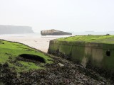 pier pontoons and other hulks dot the beach and harbor