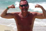 tanned hunks beach guys flexing muscles.jpg