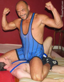 brute wrestler sitting on man.jpg