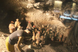 Depiction of archeologists excavating a site.