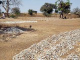 Stones from the former gold mine are cut into pieces and sold for house building, Laongo, Burkina Faso