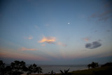 Anti-crepuscular rays and the moon at sunrise over the Pacific.
