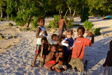 Kids on the beach with posing with a young German visitor