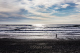 Walker on beach at Greymouth, New Zealand