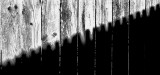 Picket shadow on a fence