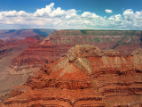 Flying In the blue sky, where the clouds reflect the Grand Canyon colors...