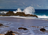 Wave crashing over rocks by Dennis