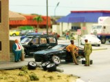 Another angle of the guy leaning on his car taking  abreak