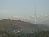 View of the Kok-Tube hill, communication tower and Alatau Mountains from Kazakhstan Hotel