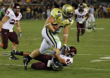 Jackets FB Mike Cox runs over Hokies LB Cam Martin