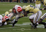 Bulldog TB Thomas Brown runs head-on into Jackets LB Guyton