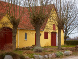 Farmhouse behind trees