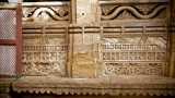 benches along carved mosque walls