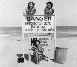 1938 - Lutrelle Conger (bottom) and friends by the unprotected beach sign on Miami Beach