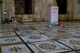 The polished floor in front of an idol, scattered with grains of rice