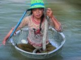 Girl in a tub -floating village, Cambodia