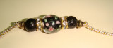 Gold cord with black rose bead and accents detail