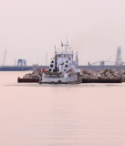 A tugboat shoves towards Kentucky Dam