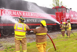 Members of the Bagdad fire Dept. wash the locomotives down during a service stop 