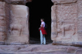 Audrey beside some carved lions at a temple