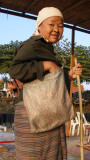 Tribal woman begging at riverbank cafe