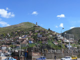 An Inca statue stands high atop a hill guarding over the ancient city of kings, Cusco.