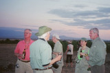 The group enjoys a drink while watching the sun go down