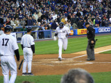 Robinson Cano touches the plate after hitting a home run