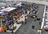 CARS BEGIN TO LINE UP ON PIT ROW FOR THE RACE START