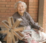 Old woman spinning in the back alleys of Bhaktapur