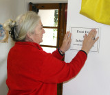 Shalom Free Clinic Executive Director and co-founder Nancy Morgans-Ferguson does her weekly ritual of putting up temporary signs