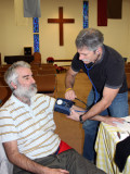Chicos Mike Jensen, at the Shalom clinic for counseling and acupuncture gets blood pressure taken by localparamedic Mark Walker