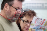720mm at ISO200 - DoF in this photo is rather short.  Clear at the glasses of the woman but a little bit blurred at the man